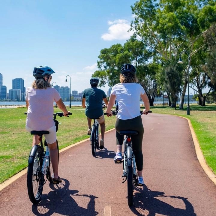 3 people wearing helmets and riding bikes in Western Australia